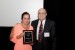 Dr. Nagib Callaos, General Chair, giving Prof. Victoria Eugenia Valencia Maya a plaque "In Appreciation for Delivering a Great Keynote Address at a Plenary Session."